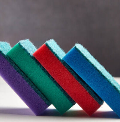 Multi colored sponges for washing dishes on a light background close up