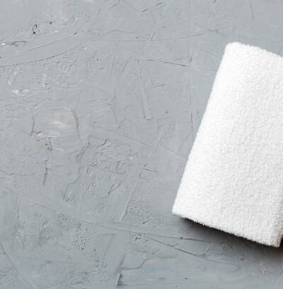 Top view of white towels with copy space on colored background.